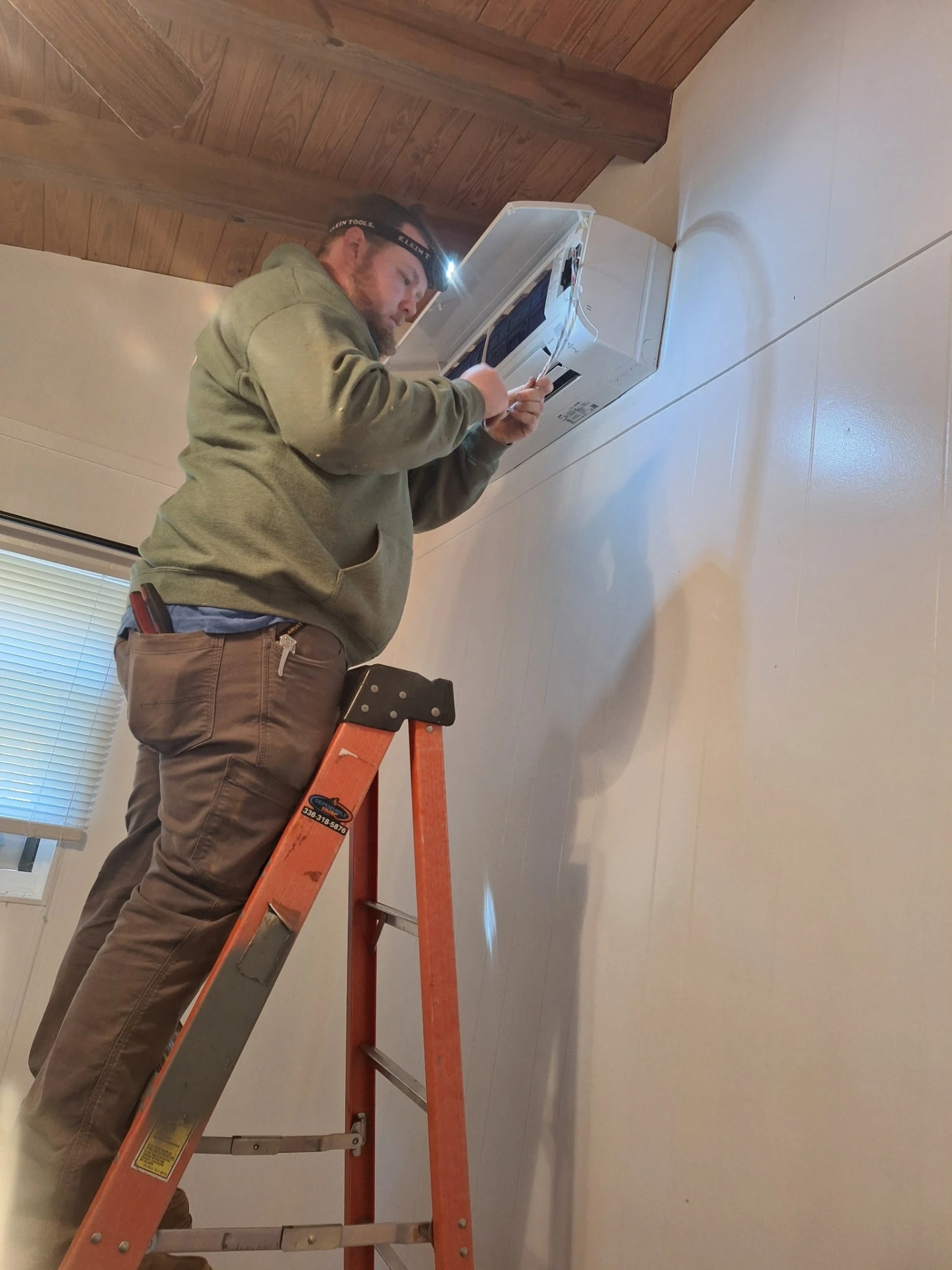 Dependable HVAC technician servicing mini-split AC unit in Albemarle NC