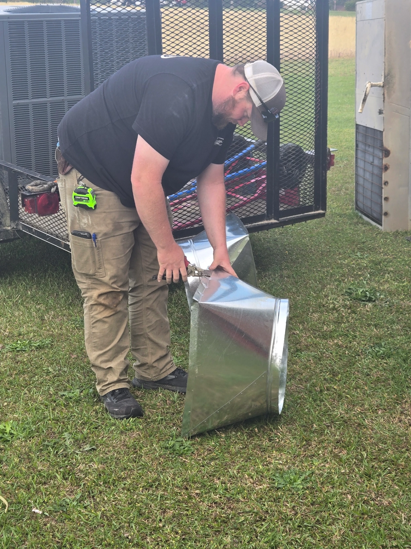 Dependable HVAC technician cutting sheet metal for custom ductwork in Albemarle NC